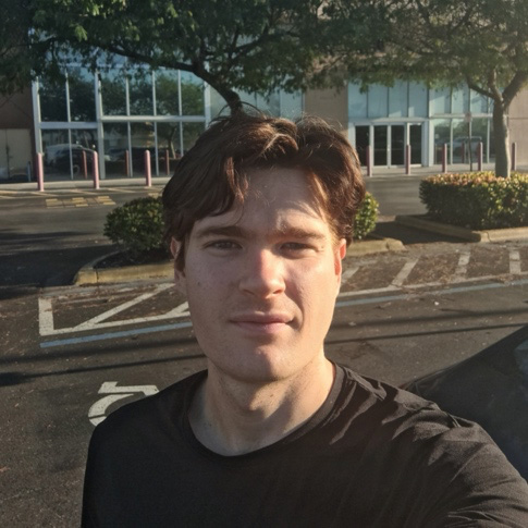  young white male standing in a parking lot